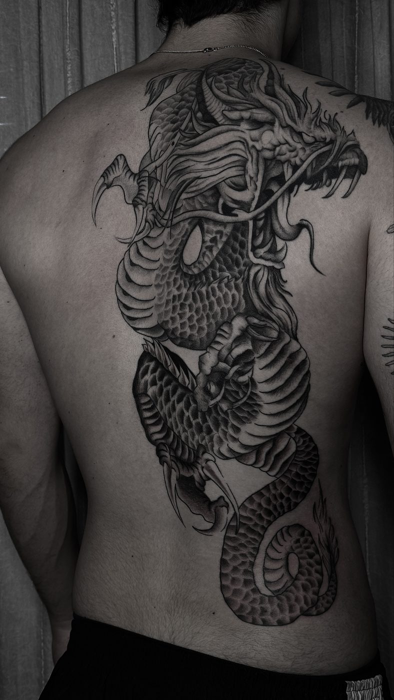 Tatuaje blackwork de dragón en la espalda